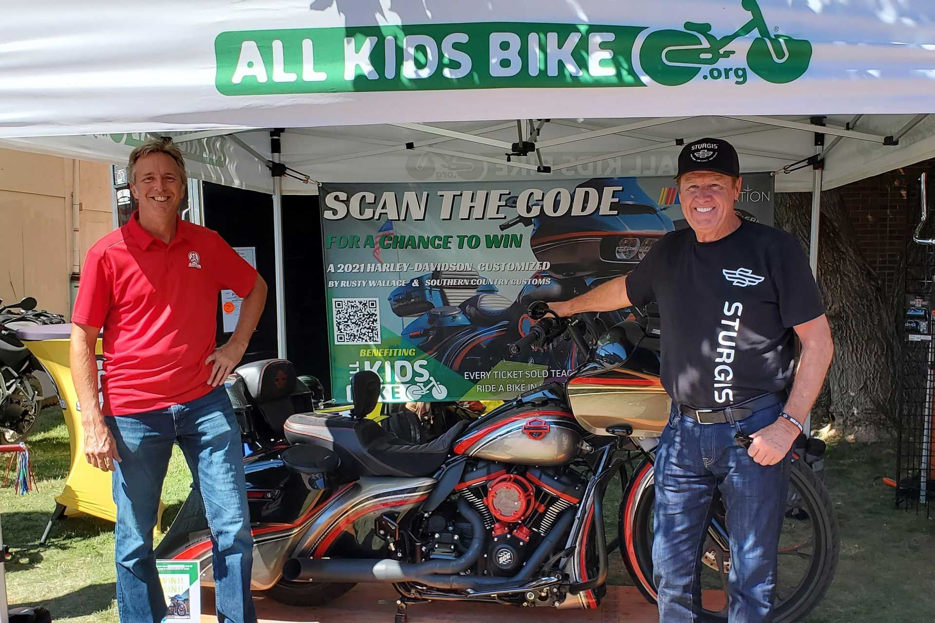 Ryan McFarland and Rusty Wallace pose with a custom Harley Davidson