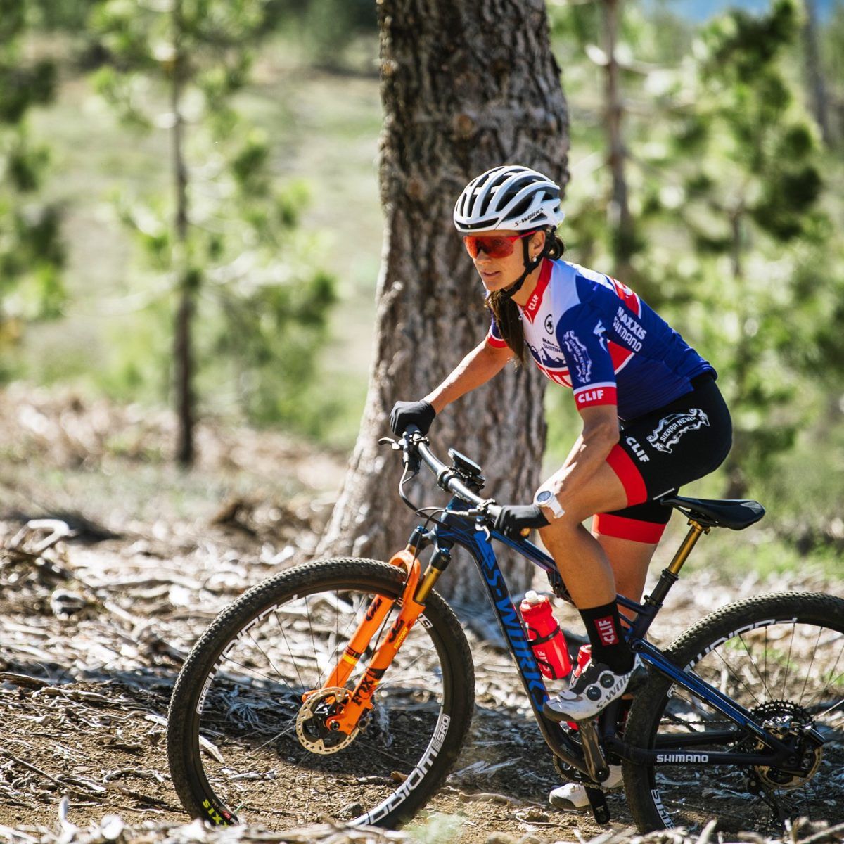All Kids Bike ambassador Katerina Nash rides a mountain bike on a forested trail