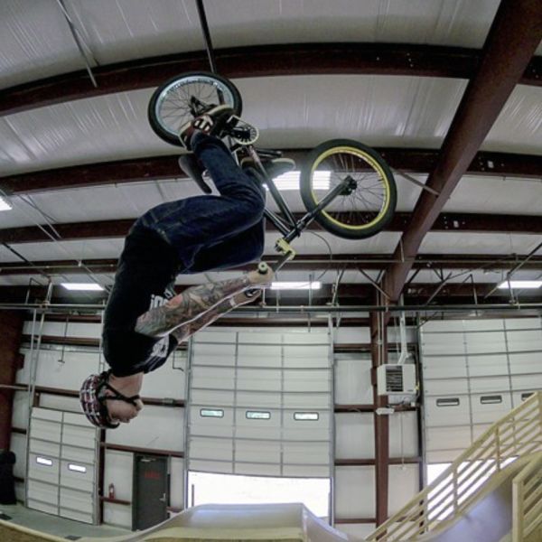 All Kids Bike ambassador Trey Hinton does a backflip on a BMX bike.