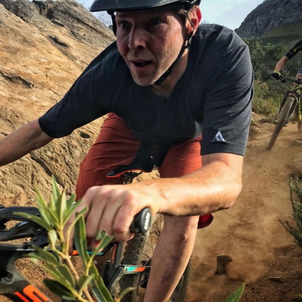 All Kids Bike ambassador Steve Blick navigates a dirt trail on his mountain bike