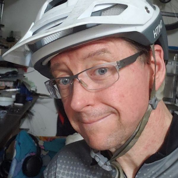 All Kids Bike ambassador Chris Currie wearing a bike helmet.