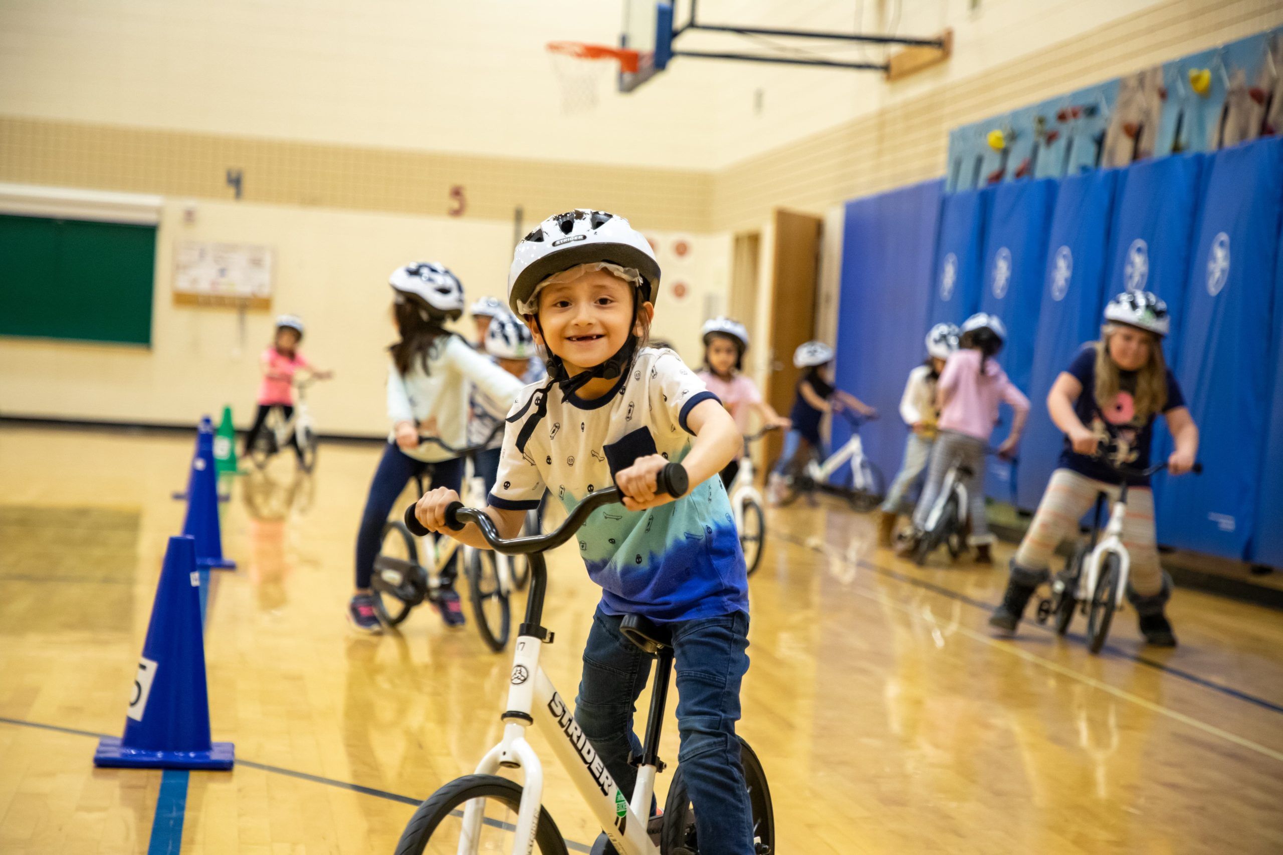 Student on Strider Balance Bike during All Kids Bike Kindergarten PE Program