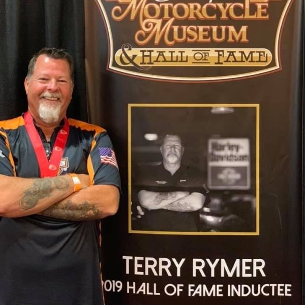 All Kids Bike ambassador Terry Rymer stands next to his Hall of Fame display