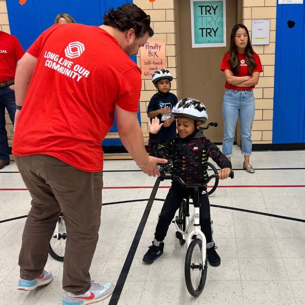 Student riding bike in kindergarten PE class