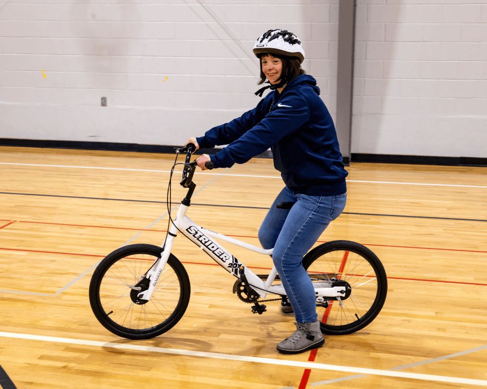 Young adult on large balance bike