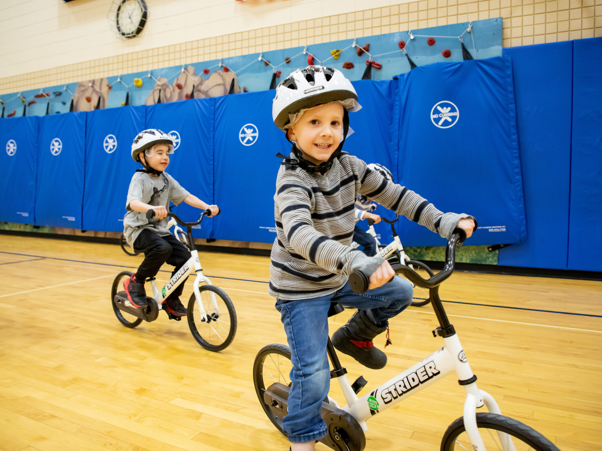 Kindergarten boy riding a bike in PE class